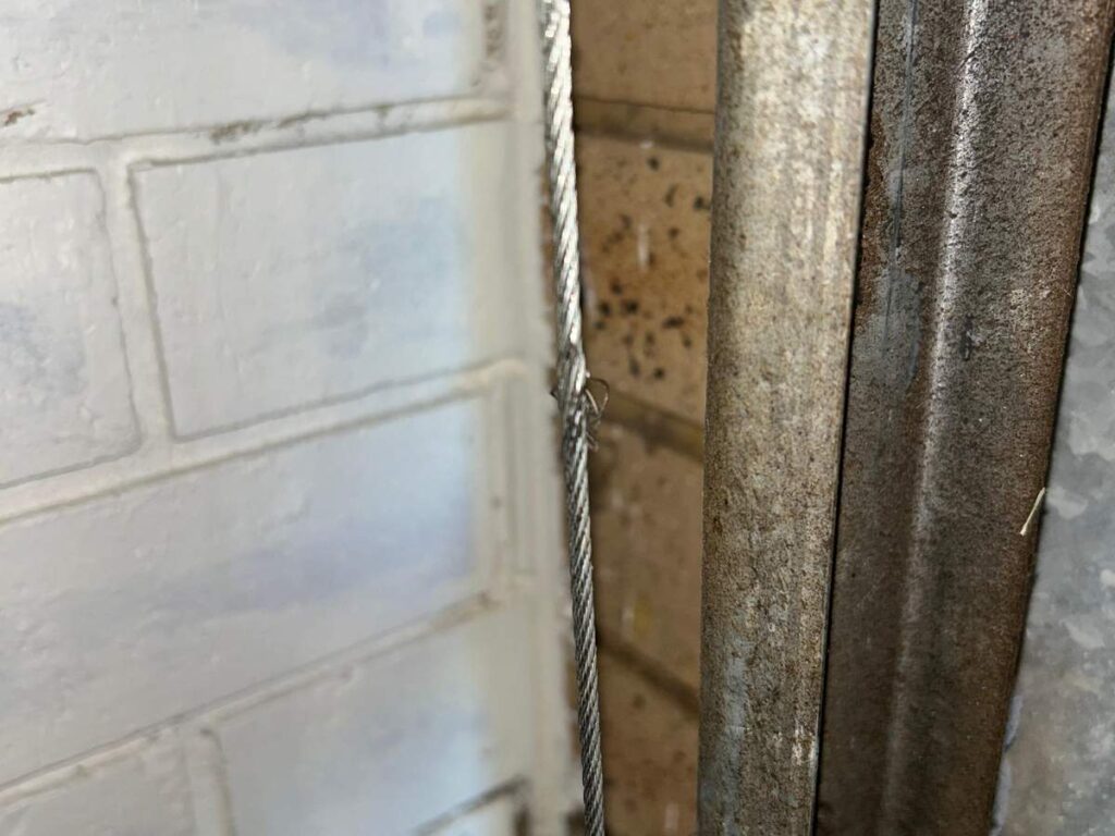 Damaged garage door lift cable requiring replacement in Willetton, Perth