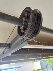 Broken strands on a worn garage door cable at the drum in Ellenbrook, Perth