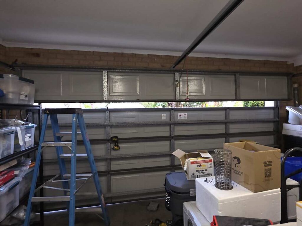 Part open sectional garage door inside a garage