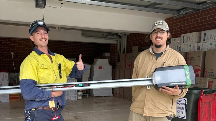 Garage door pros technician holding a brand new garage door motor