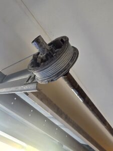 New garage door cable wound neatly onto the drum