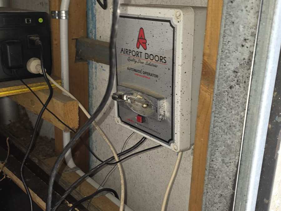 Old Airport Doors wall-mounted control panel before replacement in Elwood, Melbourne