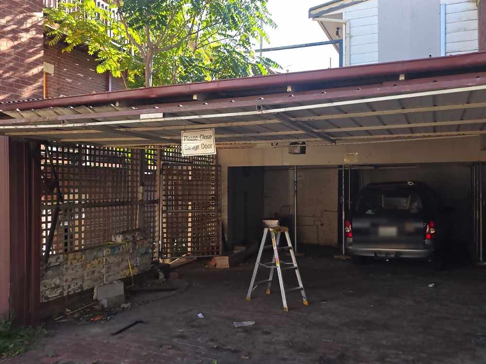 Open tilt garage door showing the garage space in St Kilda